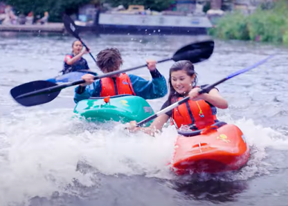 three young people kayaking