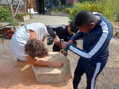Two young men working with wood